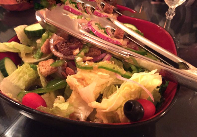 A salad of crisp greens (not local) served family style